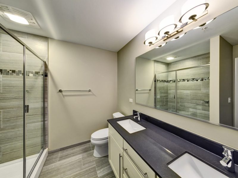 This image shows a bathroom area with designer ceramic tile floors and tub surrounds.